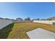 Spacious backyard with grassy area and concrete patio at 14135 Arbor Pines Dr, Riverview, FL 33579