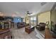 Open concept living room with leather furniture and a view into the kitchen at 14135 Arbor Pines Dr, Riverview, FL 33579