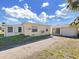 House exterior with detached garage and side yard at 14140 E Parsley Dr, Madeira Beach, FL 33708