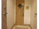 Hallway with wooden door and security panel at 1540 Gulf Blvd # 2107, Clearwater Beach, FL 33767