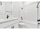 Clean bathroom, white subway tile, bathtub and shower at 1582 Running Tide Pl, Sarasota, FL 34240