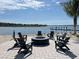 Lakefront fire pit with seating for gatherings at 1582 Running Tide Pl, Sarasota, FL 34240