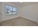 Well-lit bedroom with carpet flooring and a window with blinds at 16425 Little Garden Dr, Wimauma, FL 33598