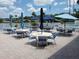 Community patio with tables, chairs and umbrellas for outdoor enjoyment at 18675 Us Highway 19 N # 137, Clearwater, FL 33764