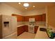 Bright kitchen with light wood cabinets, white appliances, and neutral countertops at 19409 Weymouth Dr, Land O Lakes, FL 34638