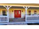 Charming front porch with a red door and rocking chairs, inviting and spacious at 2460 Richards Rd, Tarpon Springs, FL 34688