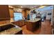 Spacious kitchen featuring granite countertops and wooden cabinets at 2460 Richards Rd, Tarpon Springs, FL 34688