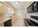 Kitchen with light cabinets, black appliances, and tile floor at 2921 Forestwood Dr, Seffner, FL 33584