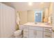 Bathroom with a toilet, sink, and shower at 29508 Chapel Park Dr, Wesley Chapel, FL 33543