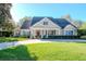 Beautiful two-story house with a charming front porch and landscaped lawn at 29508 Chapel Park Dr, Wesley Chapel, FL 33543