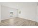 Bright bedroom featuring a large window and wood-look floors at 3005 E 17Th Ave, Tampa, FL 33605