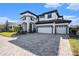 Two-story house with white exterior, dark brown accents, and a paved driveway at 32298 Talimena Loop, Wesley Chapel, FL 33543