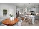 Modern kitchen with island, gray cabinets, and a wood dining table at 3234 Sunrise Spring Pl, Brandon, FL 33511