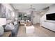 Open living room with gray sectional sofa and access to outdoor patio area at 3234 Sunrise Spring Pl, Brandon, FL 33511