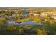 An aerial view shows the home in a green golf course with a small pond at 3401 Avenida Madera # B, Bradenton, FL 34210