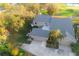 Aerial view showcasing the home's location with mature trees and three-car garage at 3401 Avenida Madera # B, Bradenton, FL 34210
