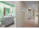 Powder room with neutral cabinet and walls, next to a hallway with tile flooring at 3401 Avenida Madera # B, Bradenton, FL 34210