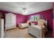 Bedroom with purple walls, two twin beds and a window for natural light at 3401 Avenida Madera # B, Bradenton, FL 34210