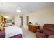 Bright bedroom with a ceiling fan, a view of the entryway, and a dresser with drawers at 3401 Avenida Madera # B, Bradenton, FL 34210