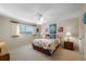 Bright bedroom with a beach theme including art and bedding, a ceiling fan, and a window at 3401 Avenida Madera # B, Bradenton, FL 34210