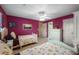 Bedroom featuring two beds, dresser, and decor, complemented by purple walls at 3401 Avenida Madera # B, Bradenton, FL 34210