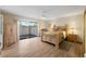 Cozy bedroom with wood floors, a ceiling fan, and sliding glass doors to the outside at 3401 Avenida Madera # B, Bradenton, FL 34210