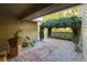 Charming courtyard entry featuring brick walkway and overhead green trellis at 3401 Avenida Madera # B, Bradenton, FL 34210