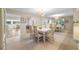 Dining room with white table and chairs, mirrored wall, and tiled floors at 3401 Avenida Madera # B, Bradenton, FL 34210