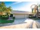 Tan two-car garage villa with landscaped yard at 3401 Avenida Madera # B, Bradenton, FL 34210