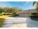 Tan two-car garage villa with driveway and lawn at 3401 Avenida Madera # B, Bradenton, FL 34210