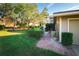 Green lawn with low landscaping and a brick path leading to the front door at 3401 Avenida Madera # B, Bradenton, FL 34210