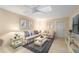 Spacious living room with light beige walls, comfortable sofas, and ceiling fan at 3401 Avenida Madera # B, Bradenton, FL 34210