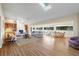 Open-concept living room with a fireplace, skylight, wood floors, and plenty of seating at 3401 Avenida Madera # B, Bradenton, FL 34210