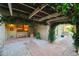 Charming covered patio with brick and white gravel flooring, a bench, and views to the home at 3401 Avenida Madera # B, Bradenton, FL 34210