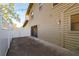 A view of the home exterior with sliding glass doors leading to a patio and yard at 3401 Avenida Madera # B, Bradenton, FL 34210