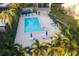 Aerial view of a community pool with plenty of seating surrounded by mature palms at 3401 Avenida Madera # B, Bradenton, FL 34210