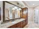 Elegant bathroom with granite countertops, double sinks, and large mirror at 3703 Douglas Pl, Palm Harbor, FL 34683