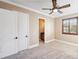 Bright bedroom with neutral walls, ceiling fan, and en-suite bathroom at 3703 Douglas Pl, Palm Harbor, FL 34683