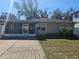 Front view of a single story house with a paved driveway at 3914 W Gray St, Tampa, FL 33609