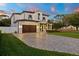 Two-story home at dusk with a lighted paver driveway at 4101 W Mullen Ave, Tampa, FL 33609