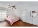 Main bedroom with ceiling fan, large bed, and hardwood floors at 4609 Horton Rd, Plant City, FL 33567