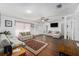 Living room featuring hardwood floors, comfy sofas, and a large TV at 4609 Horton Rd, Plant City, FL 33567