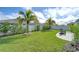 Landscaped backyard with a paved patio area at 541 Barrier Reef St, Ruskin, FL 33570