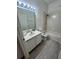 Bathroom featuring single vanity sinks, a large mirror, and a bath tub at 5733 Heronpark Pl, Lithia, FL 33547