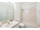 Well-lit bathroom featuring a tub-shower combo, single vanity, and modern fixtures at 5733 Heronpark Pl, Lithia, FL 33547