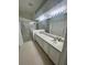 Bathroom featuring double vanity sinks, a large mirror, and a glass-enclosed shower at 5733 Heronpark Pl, Lithia, FL 33547