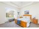 Bright bedroom with wood bed frame, large window, and window seat at 5733 Heronpark Pl, Lithia, FL 33547