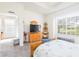 Bedroom with wood furniture, window, and access to another room at 5733 Heronpark Pl, Lithia, FL 33547