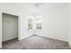 Bright bedroom with carpet, closet, ceiling fan, and two large windows at 5733 Heronpark Pl, Lithia, FL 33547