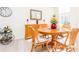 Bright dining area with wood table and chairs, buffet, and bar cart at 5733 Heronpark Pl, Lithia, FL 33547